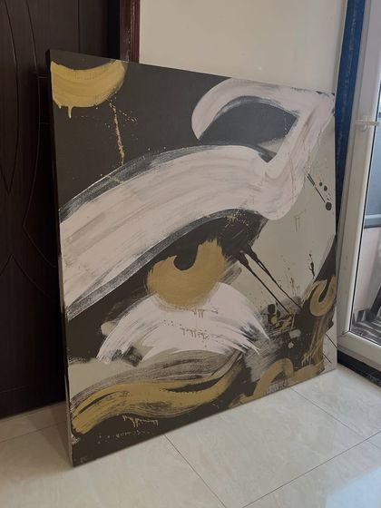 A 4ft x 4ft abstract canvas featuring bold, sweeping brushstrokes in white and gold on a dark background. This piece has a lot of movement and energy, inspired by calligraphy.