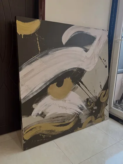 A 4ft x 4ft abstract canvas with bold, expressive brushstrokes and gold accents. This style is great for adding a touch of drama and elegance to a room.