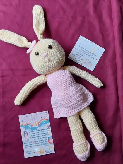 This is a custom amigurumi rabbit doll I created. Dressed in a pink dress and matching shoes, she makes a wonderful keepsake gift for a special little girl.