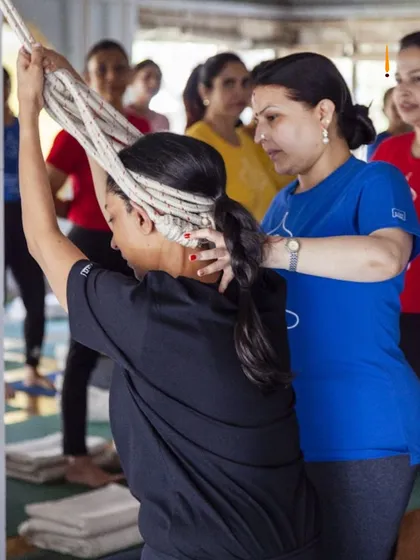 Using ropes for support is a hallmark of the Iyengar method. This student is using the rope wall to decompress her spine and open her shoulders in a way that would be impossible without the prop.