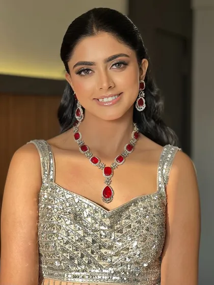 A close-up portrait of Shikha, her makeup looking fresh and radiant for her sangeet night.