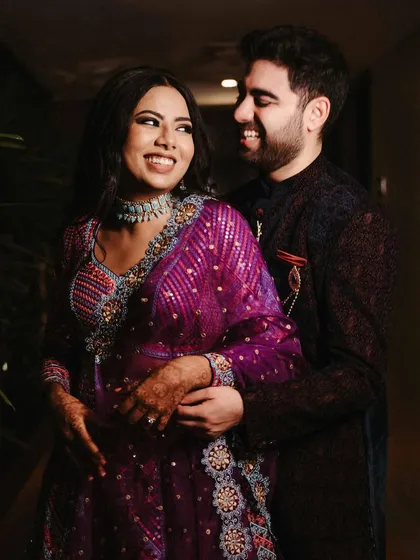 A joyful, close-up shot of Aishwarya and Archit. The warm indoor lighting and their bright smiles create a happy and intimate portrait that showcases their chemistry.