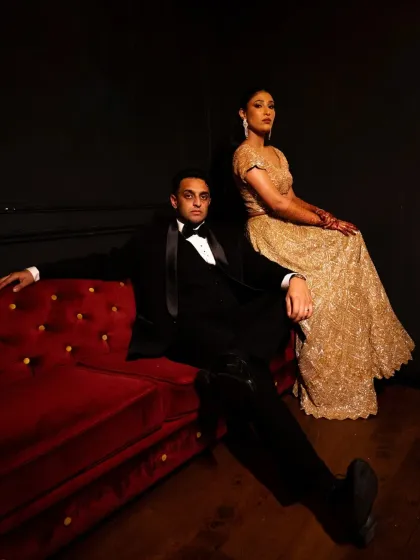 A high-fashion, editorial pose. The couple's confident expressions and the dramatic lighting create a very stylish and modern portrait.