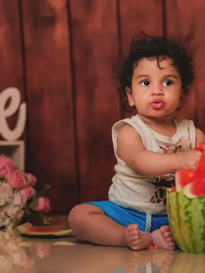 Getting hands-on with a juicy watermelon. This fruit smash session is a unique and colorful way to capture your baby's milestone moment.