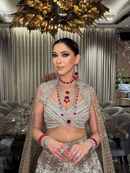 A close-up portrait highlighting the flawless makeup and the intricate details of her blouse and jewelry. A truly royal and elegant look.