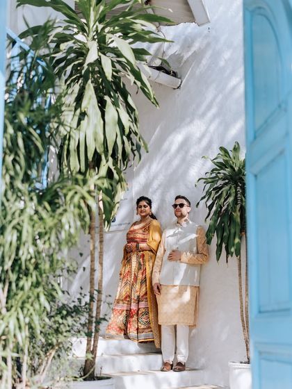 A serene moment during a Haldi function. The couple is dressed in beautiful yellow and cream outfits, perfectly complementing the sunny, relaxed vibe of their pre-wedding celebration.