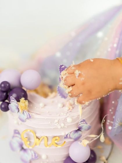 A close-up on the action. Those tiny hands digging into the cake are a memory every parent wants to keep from their baby's first birthday.