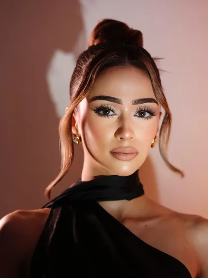 A confident portrait showcasing the bright, highlighted skin and soft glam eye.