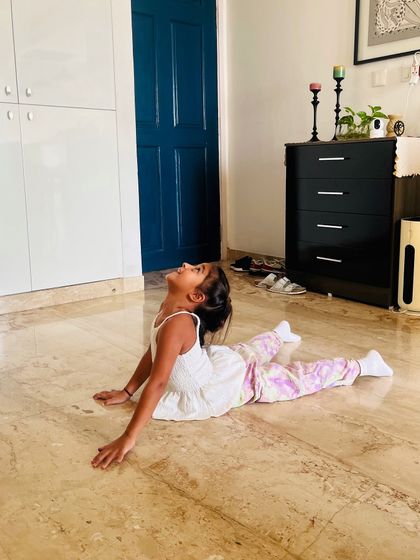 A perfect cobra pose. We guide our students to perform each asana with correct form to maximize benefits and ensure safety.