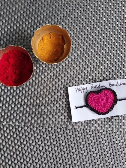 A simple and sweet heart-shaped crochet rakhi. Sometimes, the simplest designs convey the most love.