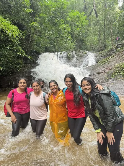 Friends enjoying a dip in a stream on the Kodachadri trail.