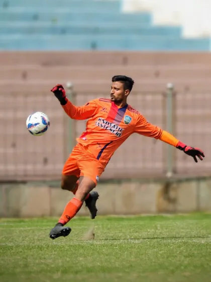 Our goalkeeper in action, demonstrating his skill and control.