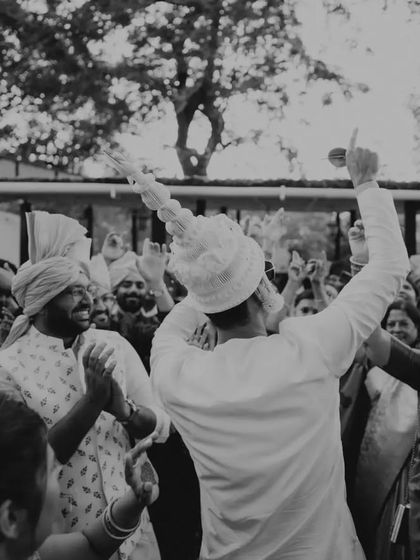 The groom's grand entrance, full of energy and celebration! This black and white photo perfectly captures the excitement and joy of the baraat.