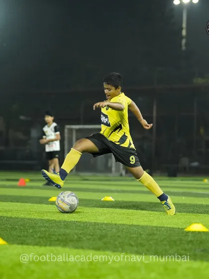 Dribbling drills under the floodlights. We train day and night to ensure our players are always ready to perform.