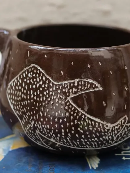 'The Lost Marines' is a set of three mugs I created using the Mishima technique on black clay. I carved the designs and inlaid them with white slip, creating a stark, beautiful contrast that I love.