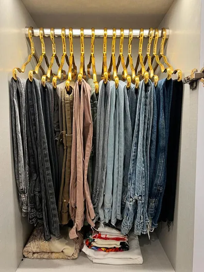 Hanging jeans and trousers on matching hangers not only looks great but also makes them easy to see and access.