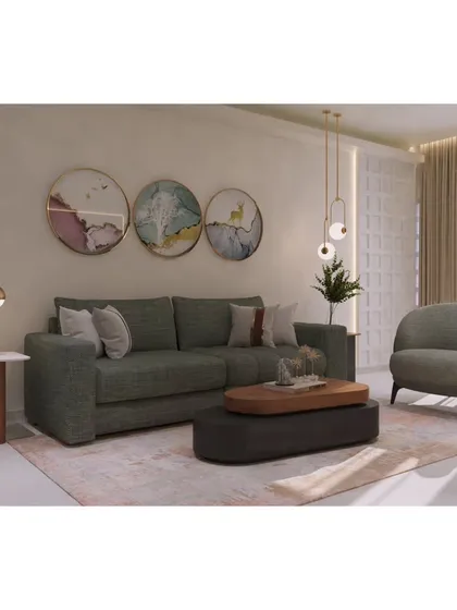 A full view of the seating arrangement, featuring a comfortable three-seater sofa and a matching accent chair. The mix of textures and art creates a welcoming and stylish environment.
