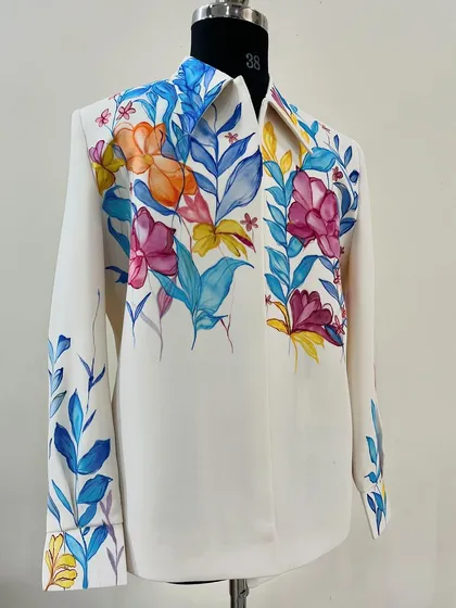 The full view of the watercolor-style floral shirt. The vibrant colors and abstract shapes make this a standout piece that is full of energy and life.