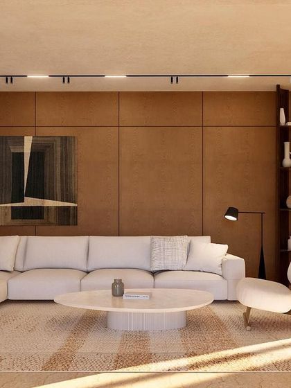 The informal living room at Kumo House features rich wood-paneled walls and a plush sectional sofa. It's a cozy, inviting space designed for relaxation and intimate family moments.