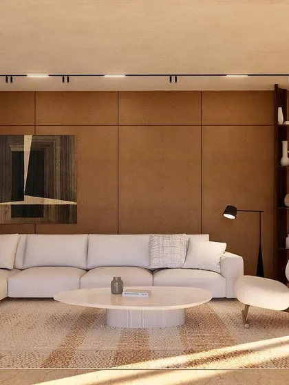 The informal living room at Kumo House features rich wood-paneled walls and a plush sectional sofa. It's a cozy, inviting space designed for relaxation and intimate family moments.