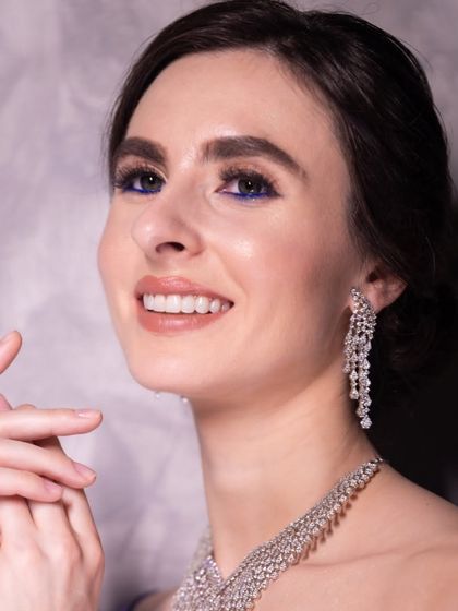 The complete look with stunning diamond jewelry and a pop of blue liner, ideal for a glamorous cocktail party.