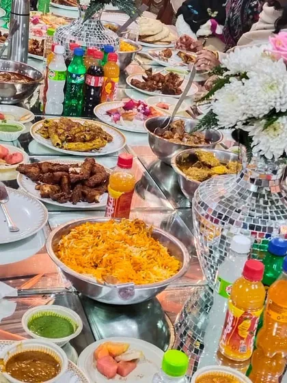 This is what barkat looks like. A table full of our food, with guests enjoying everything from Chicken Biryani to fried starters. We make sure there's more than enough for everyone to eat to their heart's content.
