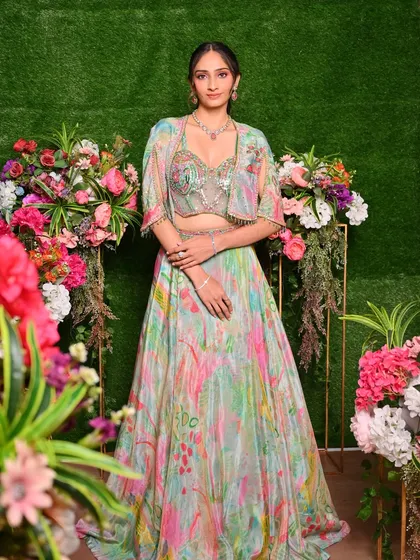 A full-length shot showcasing a student's work on a floral lehenga look, perfect for a day wedding or mehendi ceremony.