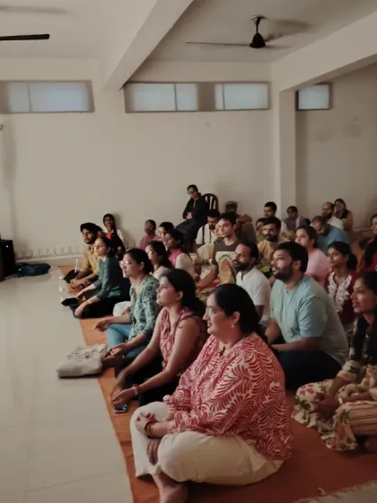 A view of our Sangha, our spiritual family, gathered for the Guru Purnima celebration. The room is filled with seekers from all walks of life, sitting together in shared reverence and joy.