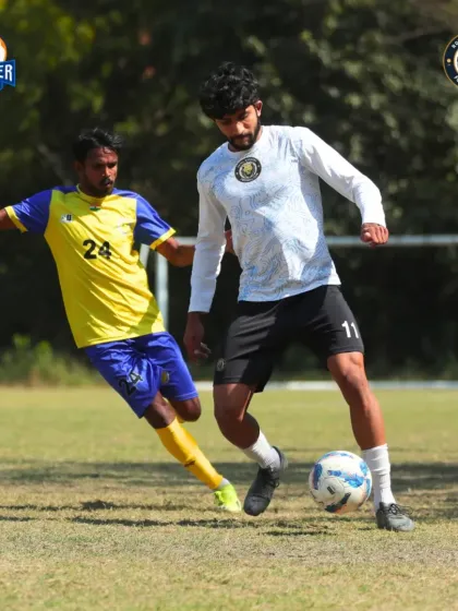 Dribbling past a defender. A moment of skill and agility as our player looks to create a scoring chance.