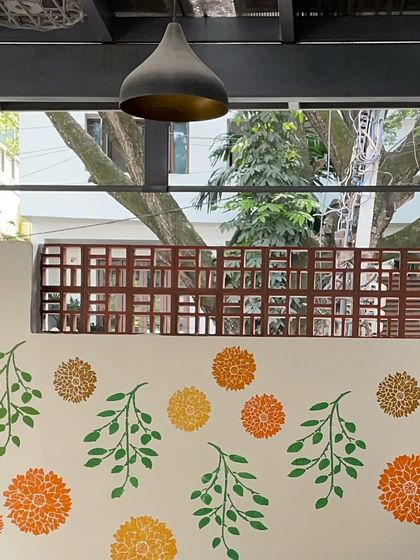 The walls of my studio are decorated with stenciled floral and leaf motifs, creating a cheerful and creative ambiance for all who visit.