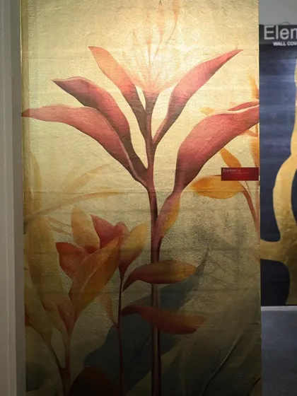 A large-scale floral wallcovering with a golden background, displayed at our booth. We aim to bring designs that are not just wallpapers, but true works of art, to our clients.