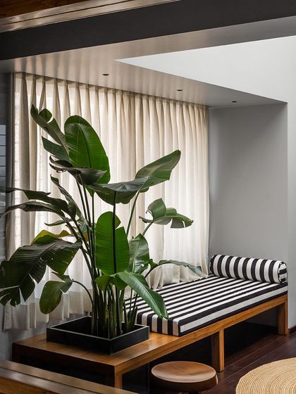 This timber bench with an integrated planter box is a piece I designed for a master bedroom lounge. It combines seating with greenery, creating a functional and peaceful element by the window.