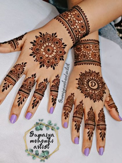 The back-hand design for the engagement, with a personalized initial 'D' in the mandala.