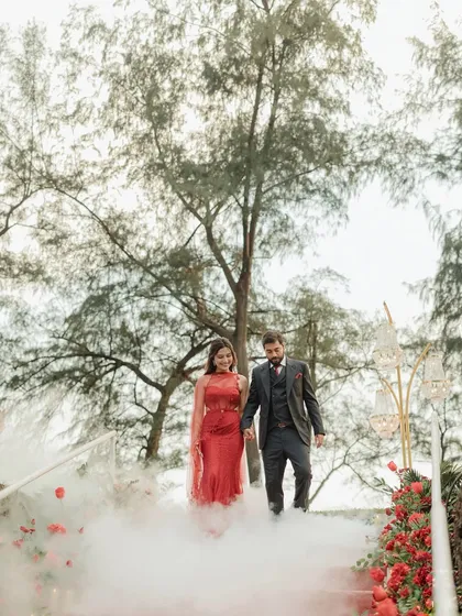 The couple's dramatic entrance for their engagement party, walking down a staircase through a cloud of smoke.