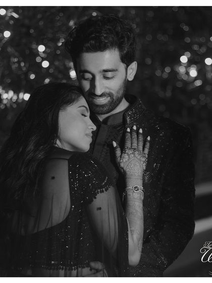 A classic black and white portrait of the couple. This timeless shot from their Sangeet night captures their elegance and deep connection.