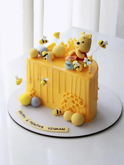 A different angle of the adorable Winnie the Pooh half birthday cake.