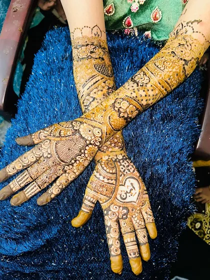 A stunning bridal design for "Ameen ki dulhan," with his name beautifully written in a heart on her palm.