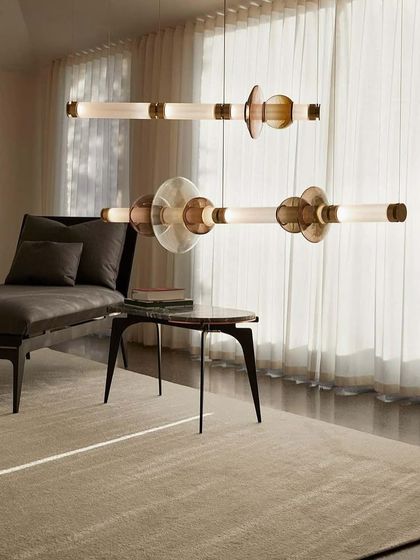 Two horizontal Luna fixtures are layered in a living space, creating depth and a warm, diffused light. The arrangement demonstrates how these modular lights can be used to define different zones within an open-concept room.