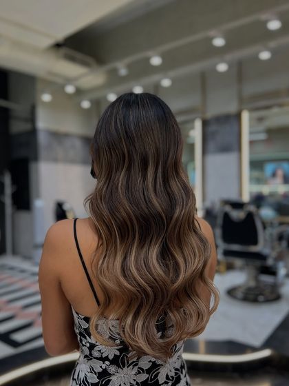 A perfect example of a Redken balayage transformation. The color melts from a natural root into lighter ends, creating a beautiful ombre effect that is both modern and timeless.