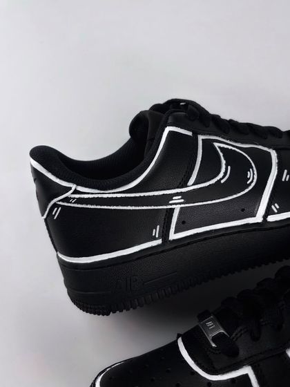 A close-up of the heel of the black cartoon custom sneaker.