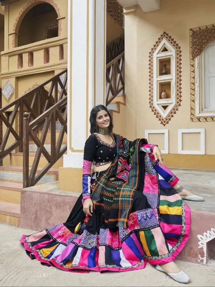 The model seated in the Navratri lehenga, showing its beautiful flare and detailed work.