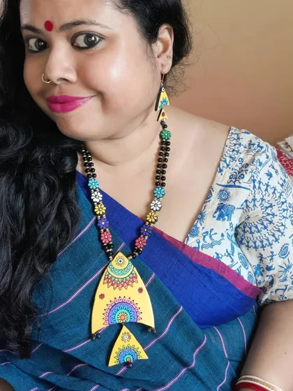 A duplicate image of me wearing the artistic fish necklace.