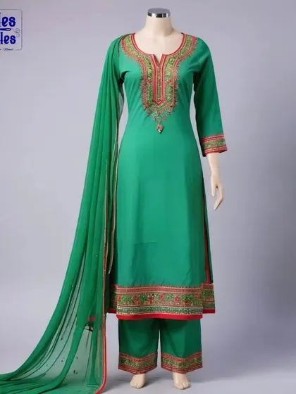 A classic green suit set with palazzo pants, displayed on a mannequin. The detailed embroidery on the neckline and hem adds a touch of traditional elegance, perfect for formal gatherings.