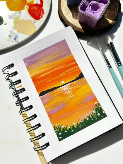 A simple and beautiful sunset over the water, painted with gouache in my sketchbook. The reflection of the sun on the water is the main focus.