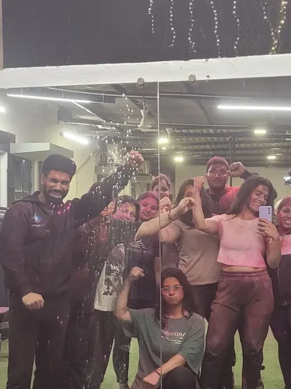A group photo capturing the colorful chaos of our Holi event. So much fun with this crew.