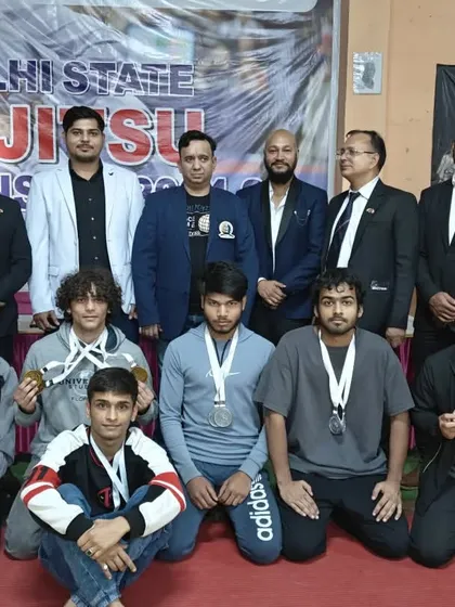 Our medal winners posing with officials at the Delhi State Ju-Jitsu Championship, a proud moment for the team.