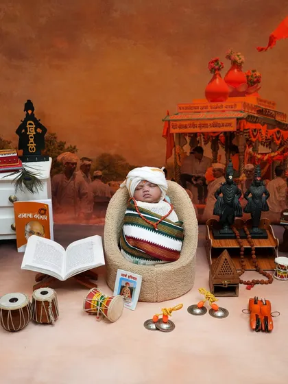 Our Vitthal theme is a tribute to our deep-rooted traditions. This detailed setup for a newborn includes everything from the Vithoba idols and tulsi plant to the tiny cymbals and dholki, creating a truly spiritual and culturally rich portrait.
