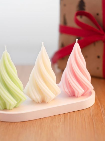 An inspirational photo showing finished spiral Christmas tree candles made with my molds. The elegant design looks beautiful in various colors, perfect for holiday decor.