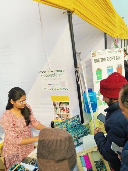 Engaging with visitors at our stall during a busy event. We believe that seeing our products in person helps people understand the potential of recycled materials.