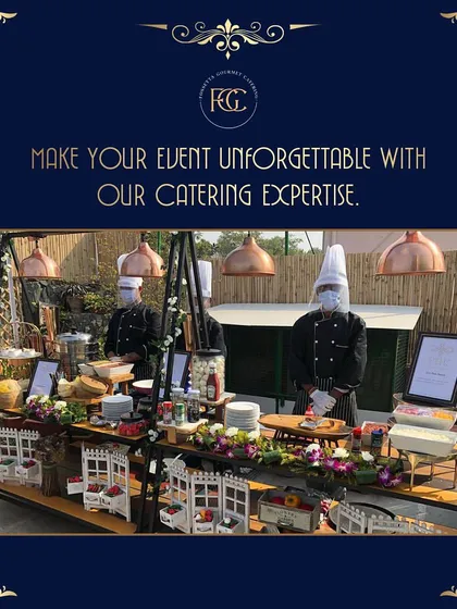 A wide view of one of our charming live station setups, designed with rustic white picket fences and floral details. Our chefs are ready to serve guests with a smile.
